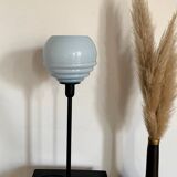 Table lamp with a vintage powder blue globe and a black base