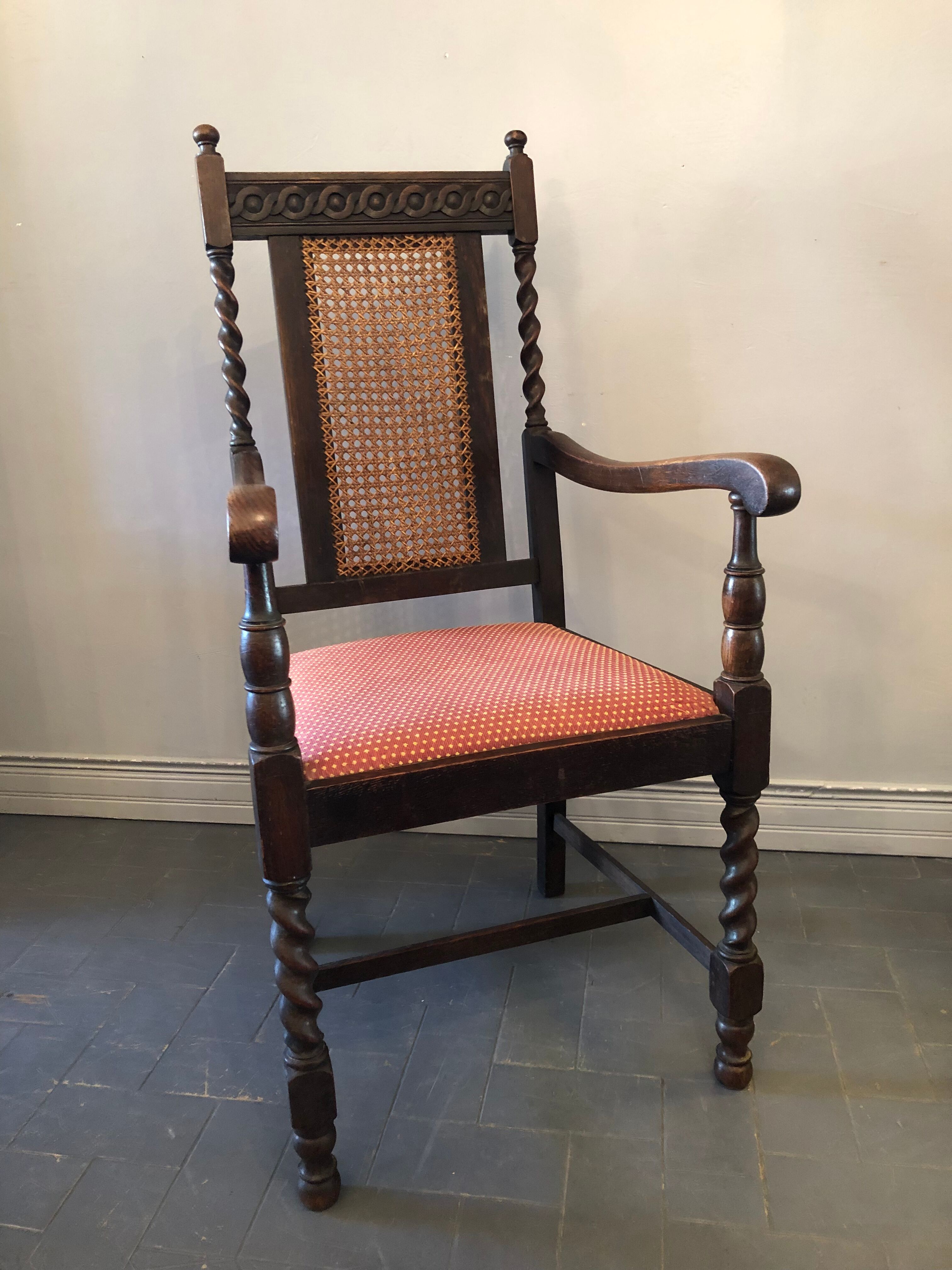 Carved wooden armchair and cannage