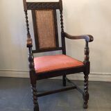 Carved wooden armchair and cannage
