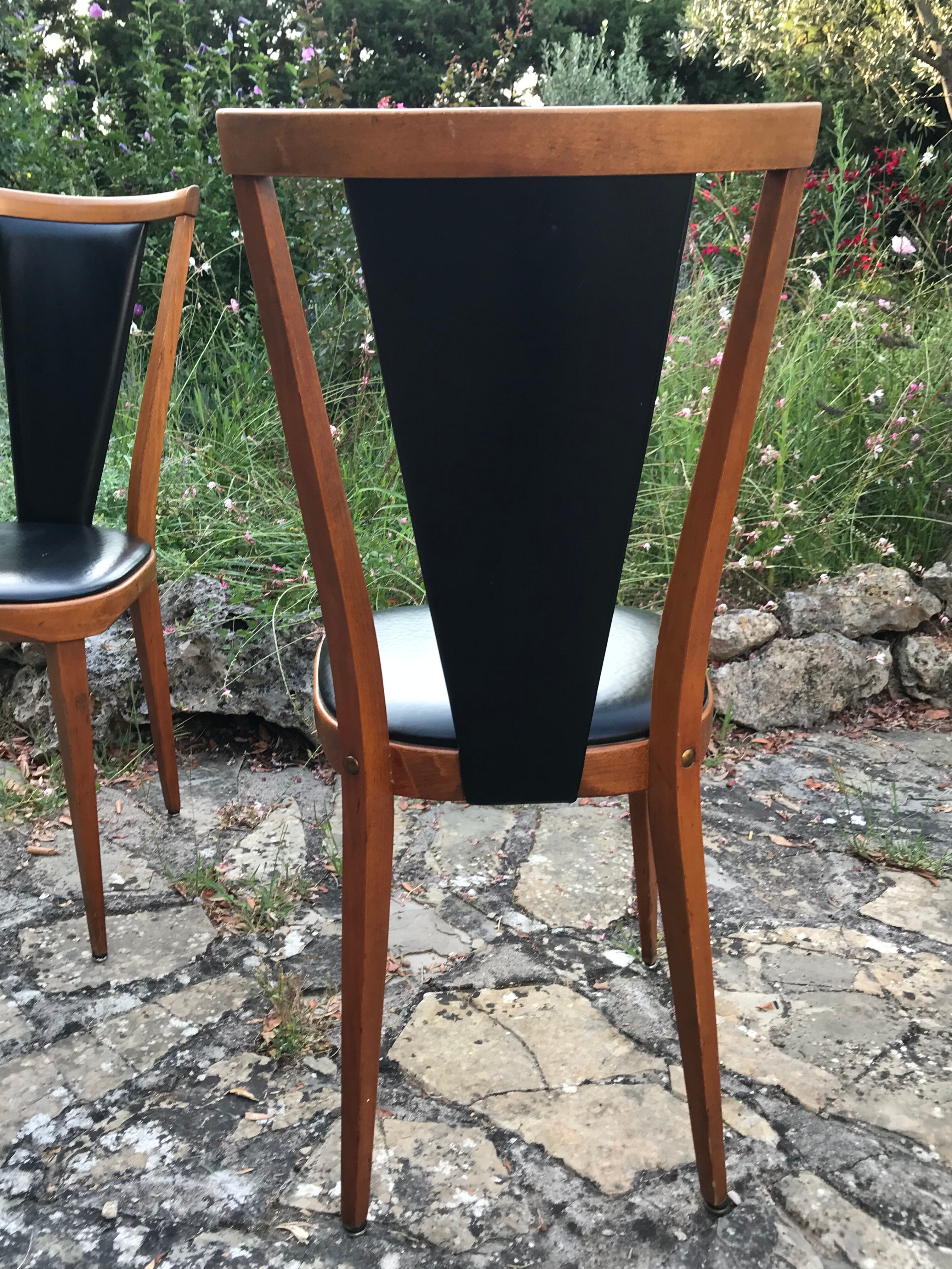 Four vintage beech and skai chairs