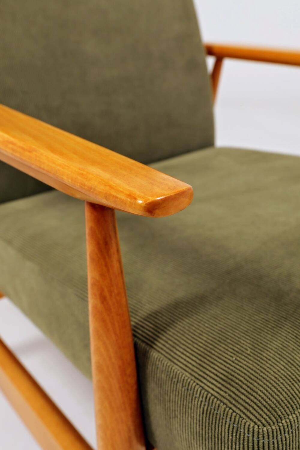 Mid-century modern design armchair in olive green corduroy.