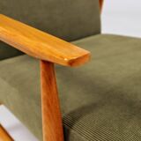Mid-century modern design armchair in olive green corduroy.
