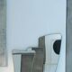 Contemporary rectangular mirror with rounded edges and embossed brass frame.
