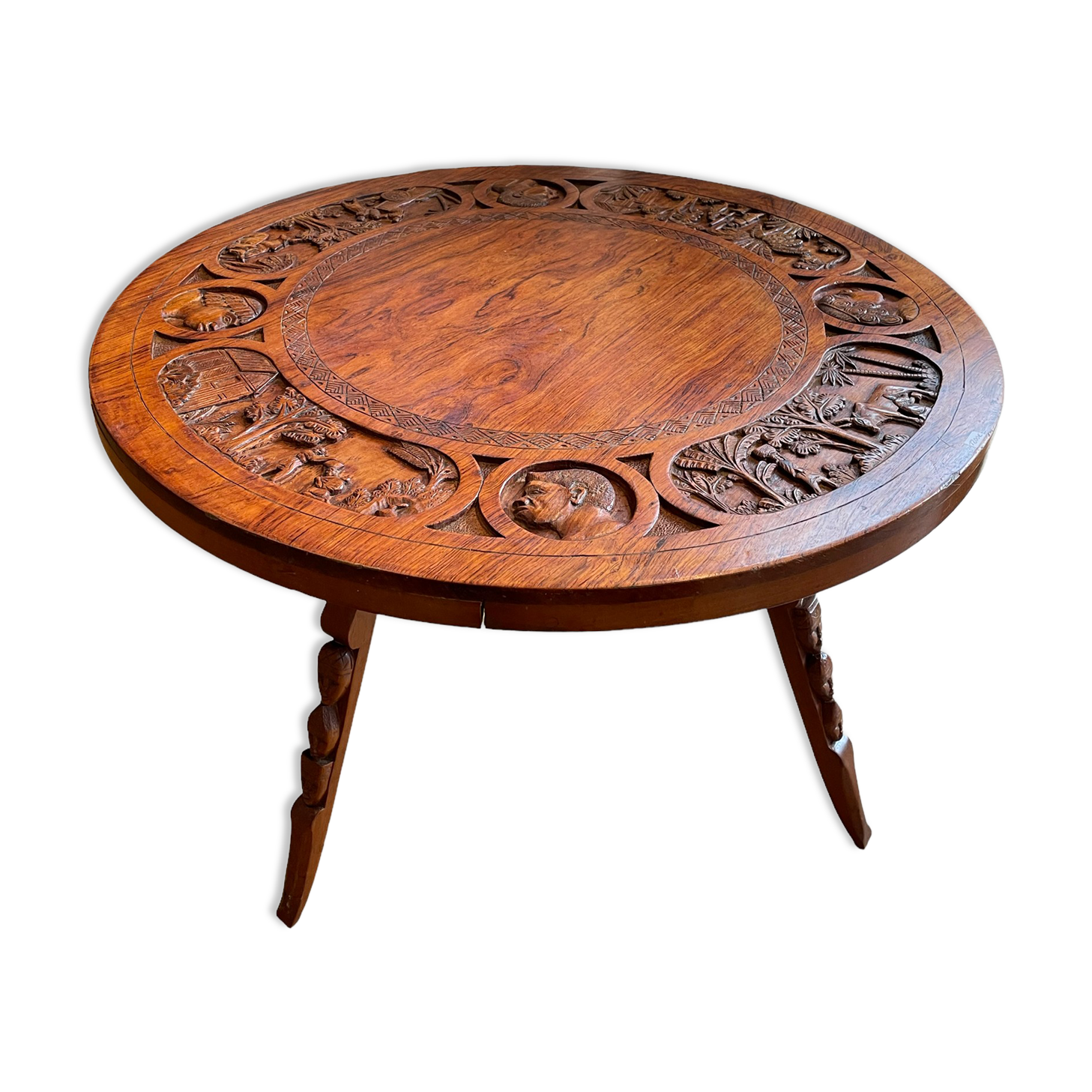 Circular tripod coffee table in carved wood