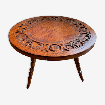 Circular tripod coffee table in carved wood