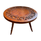 Circular tripod coffee table in carved wood