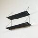 Mid-century vintage shelf in a loop shape, black glass and metal.
