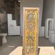 Rectangular Indonesian construction element with blue and yellow plant in carved wood