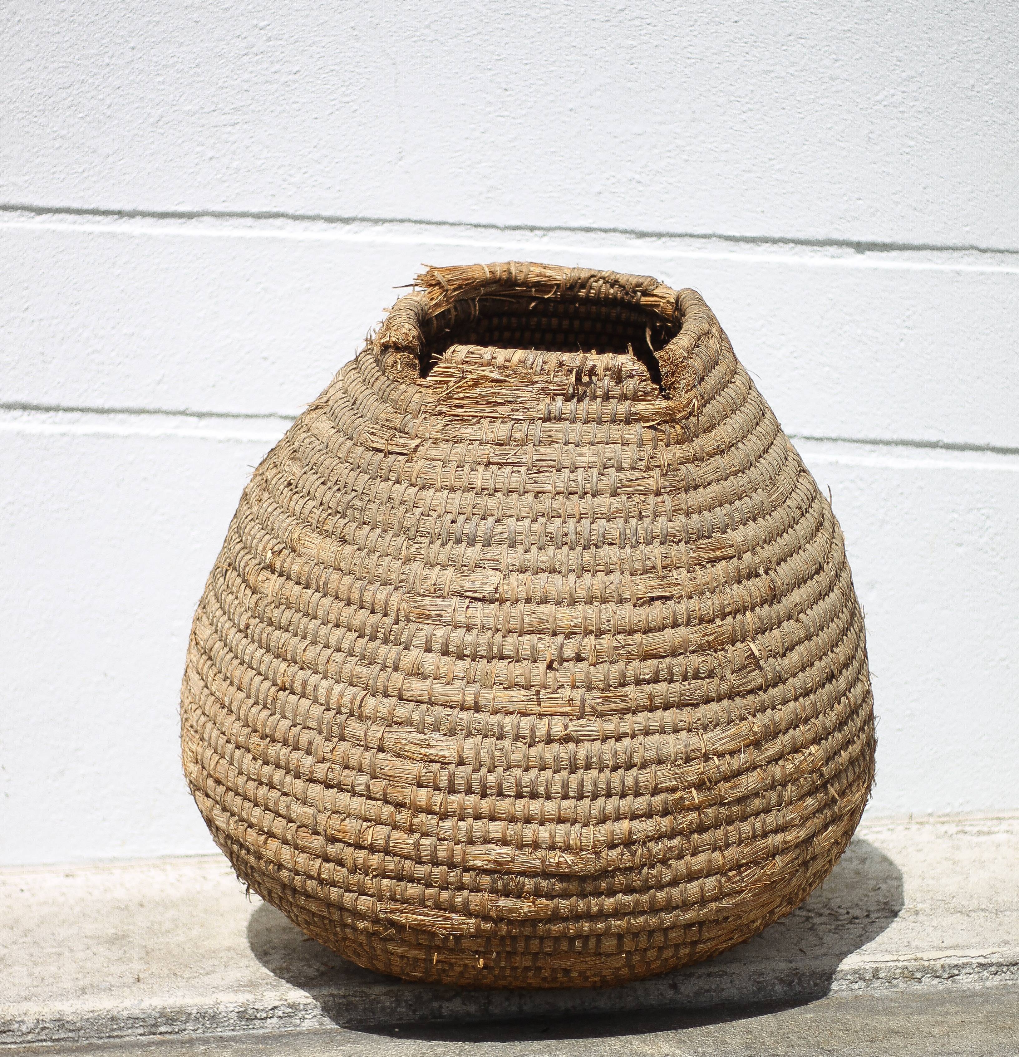 Old basket, burgundy straw and bramble, woven basket, interior decoration, pantry, flowerpot