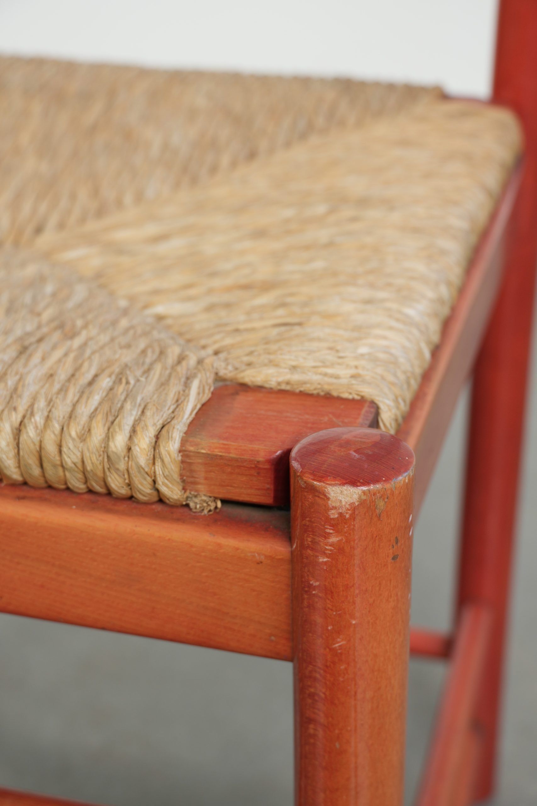 Nice red vintage wooden chair from the 1970s with a woven wicker seat