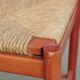Nice red vintage wooden chair from the 1970s with a woven wicker seat