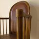 Antique armchair in solid wood and patinated brown leather, early 20th century.