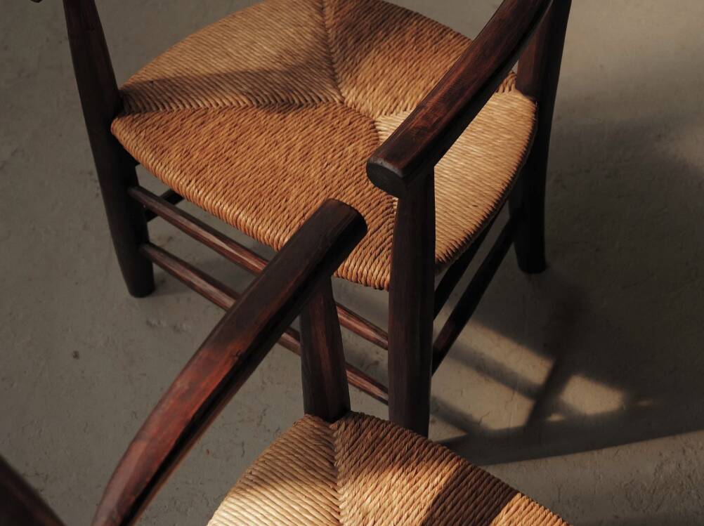 Pair of solid wood and straw armchairs, France, circa 1950.