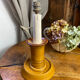 Candle holder-style lamp made entirely of ceramic.
