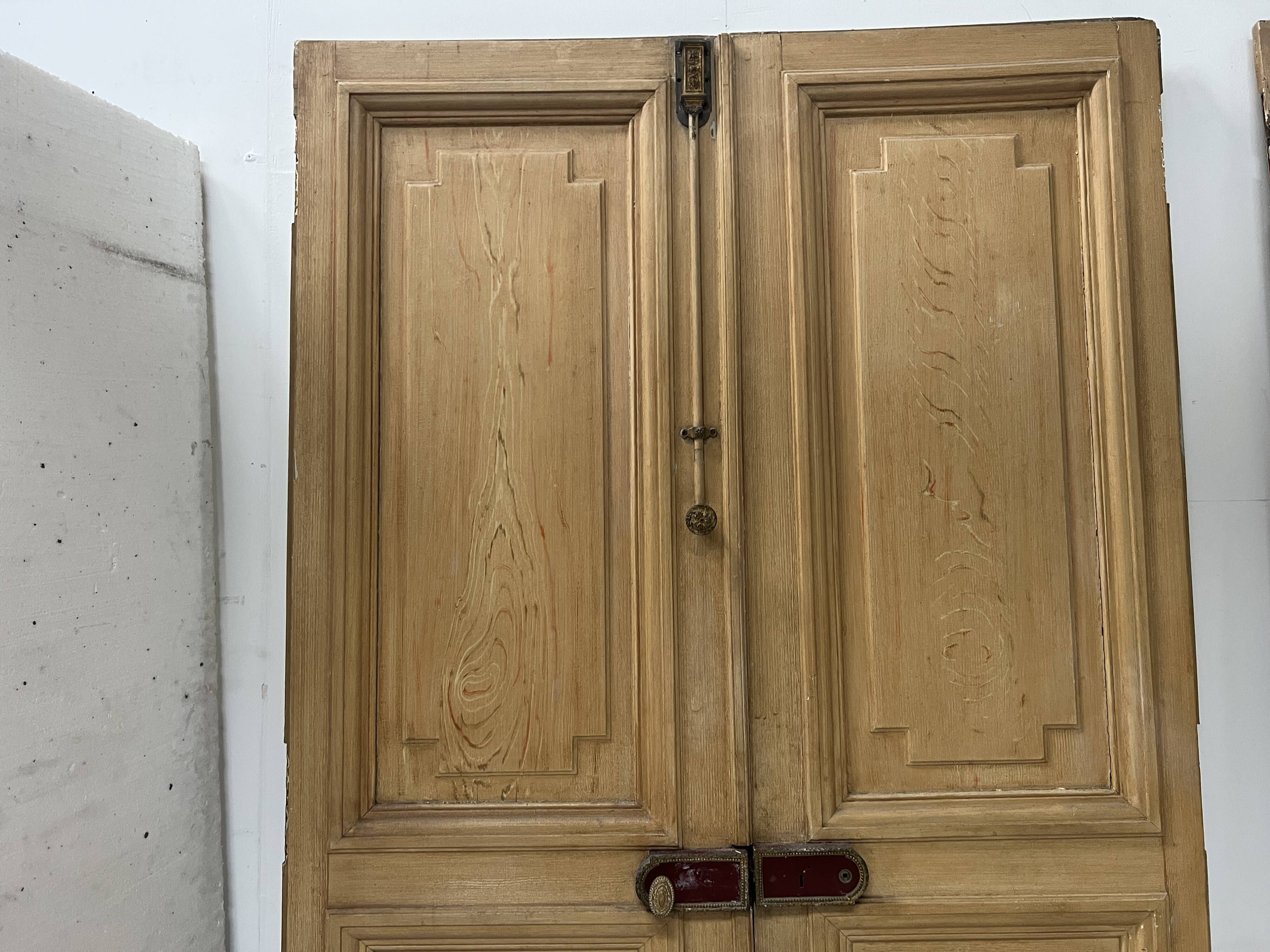 Pair of Haussmann-style double passage doors in patinated oak from the 19th century.