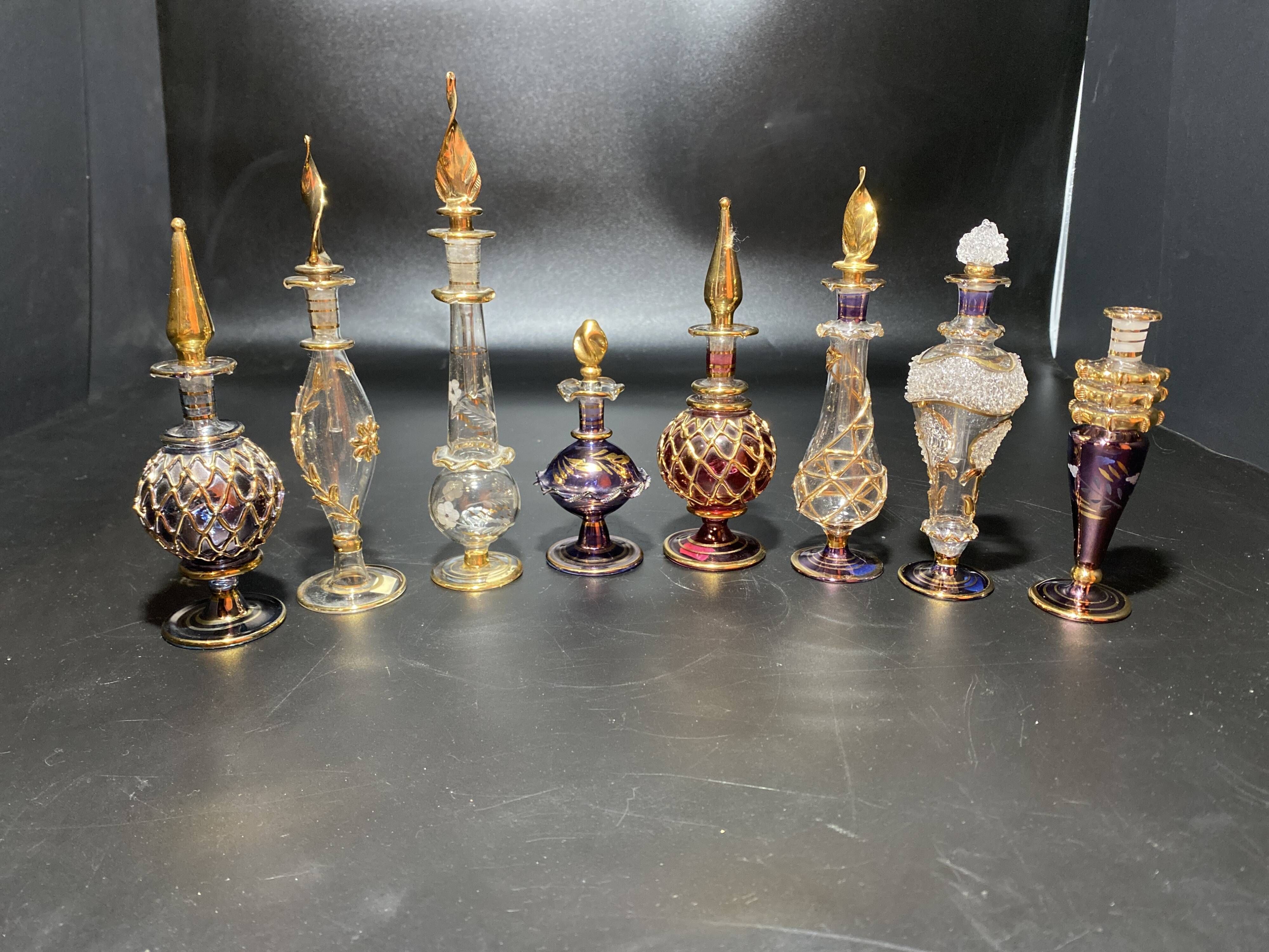 Set of 8 blown glass perfume bottles gilded with 12 carat gold