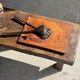 Small rectangular teak monoxyle cutting board with a circular handle.