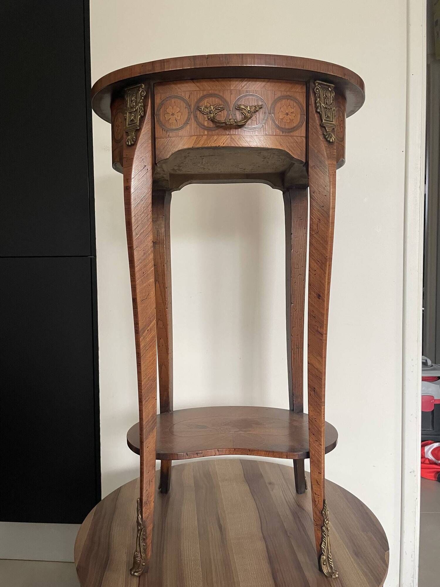 Oval bedside table from the Transition period in marquetry and bronze.