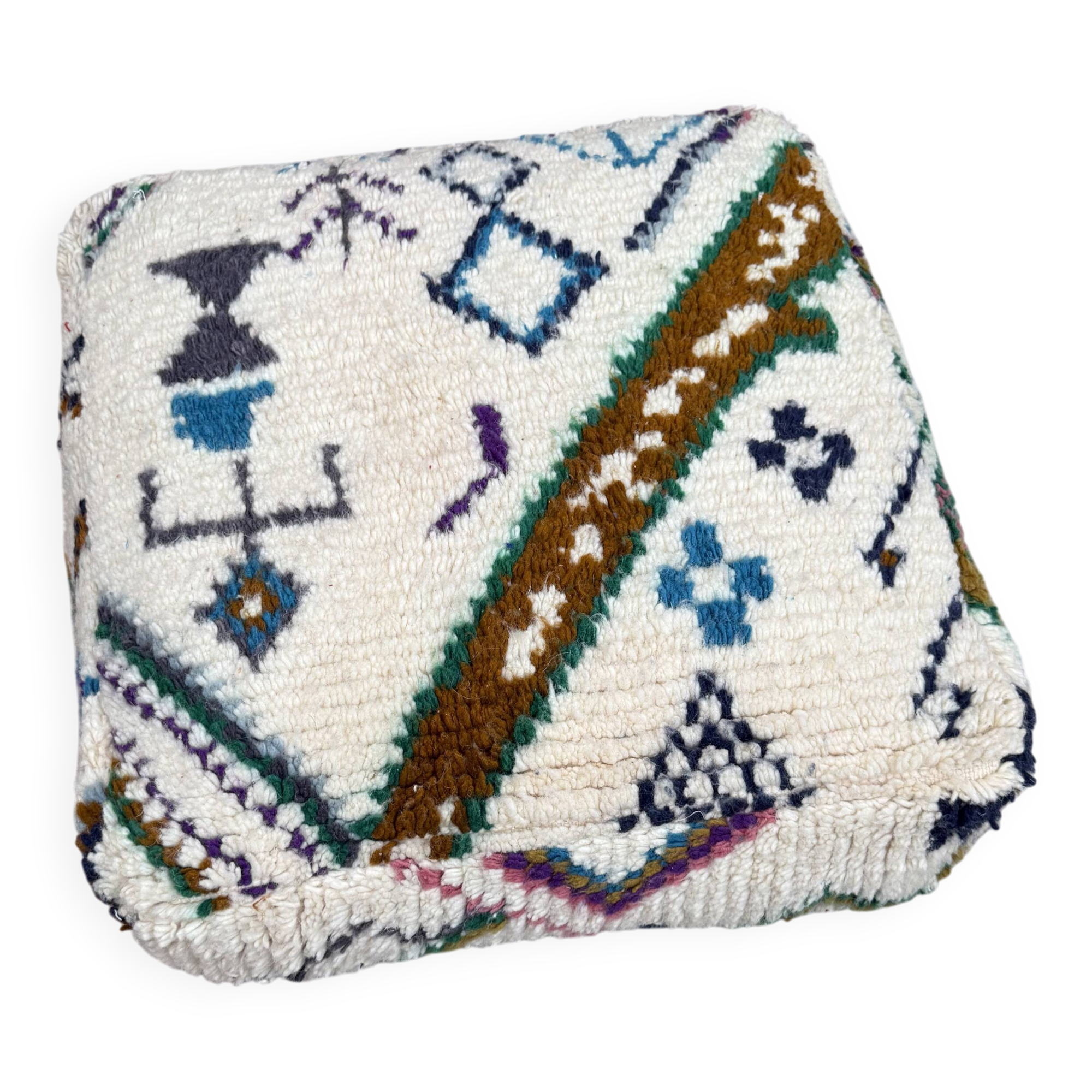Berber floor pouf: Handwoven Moroccan wool cushion.