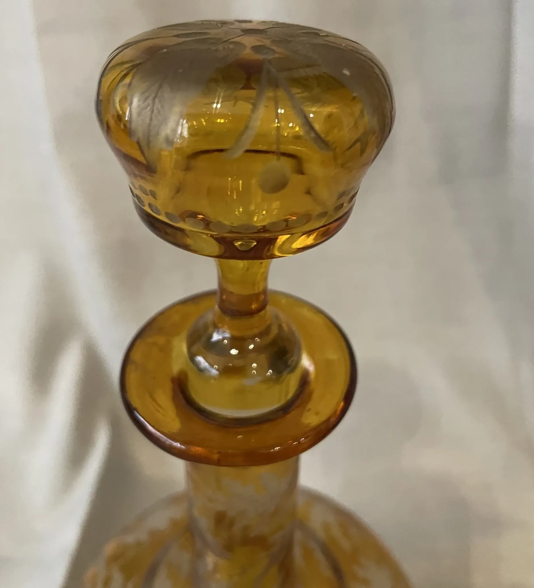 Amber bohemian glass liqueur carafe decorated with a stag in the forest.