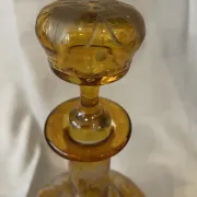 Amber bohemian glass liqueur carafe decorated with a stag in the forest.