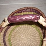 Round and colorful straw basket with handles