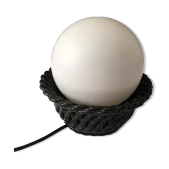 Table lamp with black porcelain support in the shape of a woven basket and opaque glass ball globe
