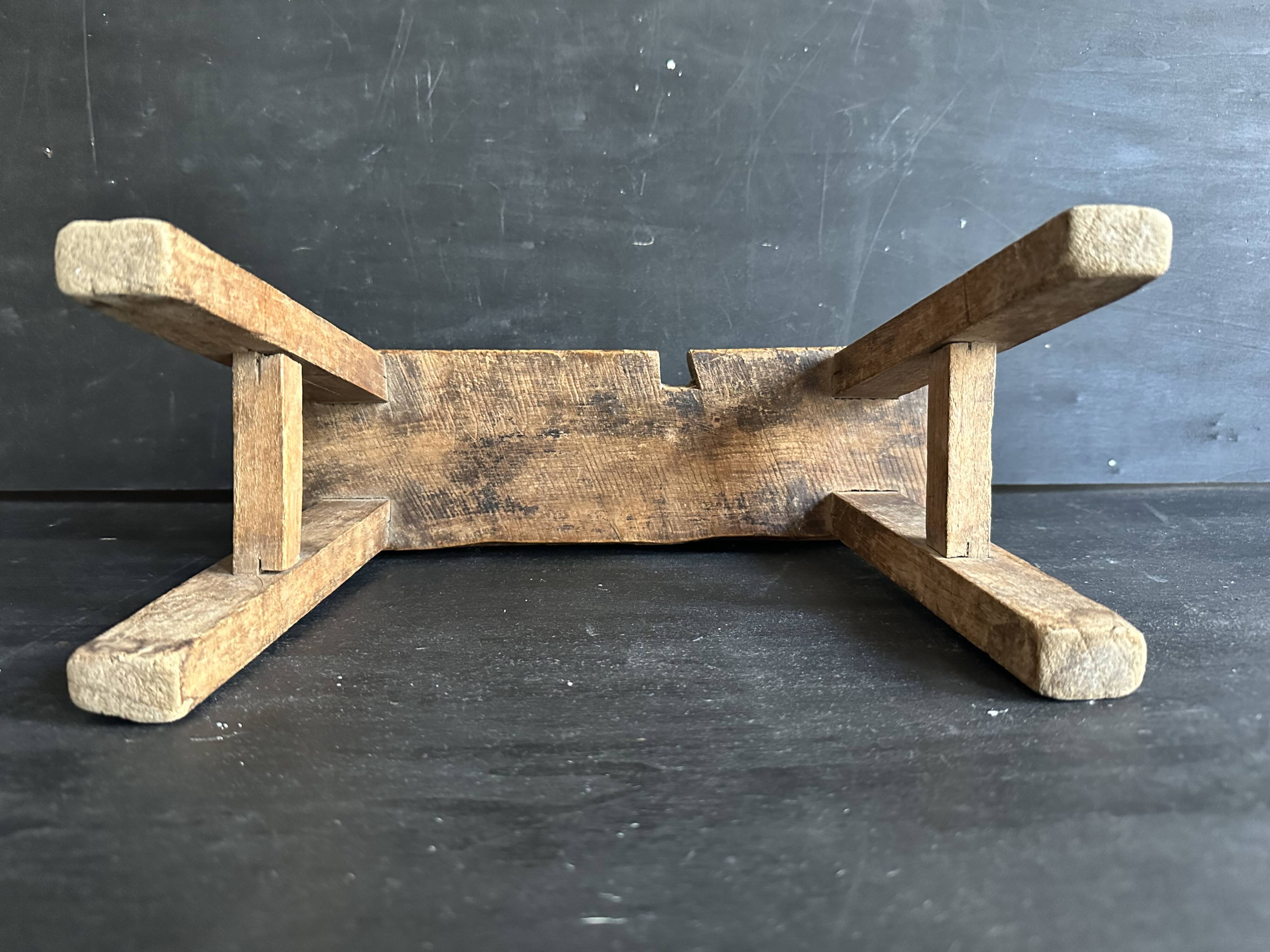 Ancient Chinese farm bench in patinated wood, small rustic stool.