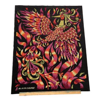 Tapestry stretched on a wooden frame representing a bird in flames