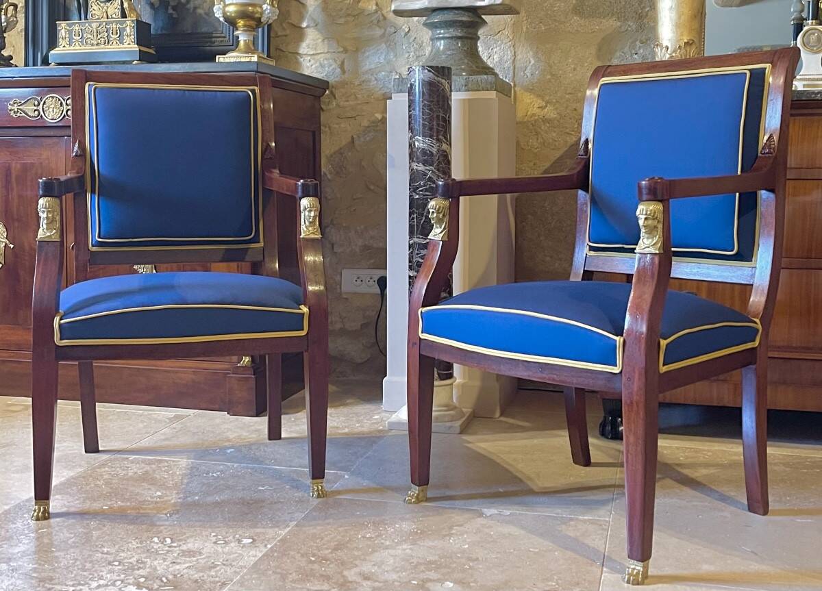 Pair of Empire style armchairs in mahogany and gilt bronze.