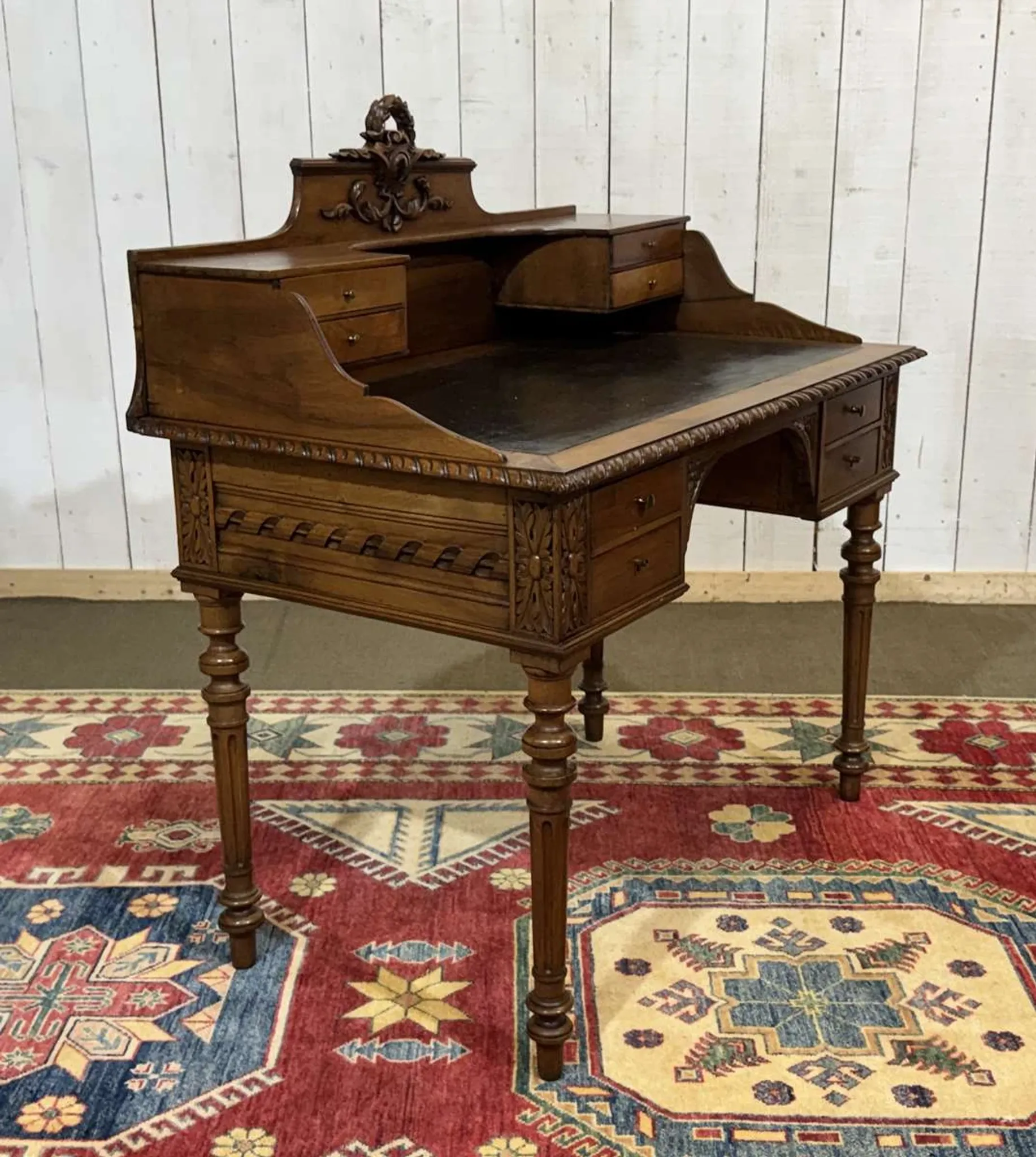 Louis XVI style desk from the late 19th century in walnut with a leather top.