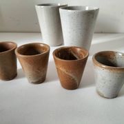 Set of 8 stoneware cups and a mug, shades of beige.