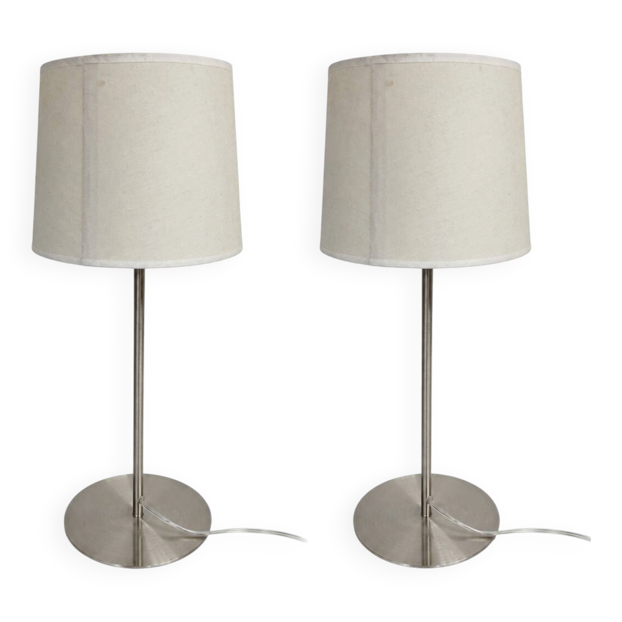Pair of large brushed metal lamps with cream shades.