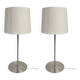 Pair of large brushed metal lamps with cream shades.