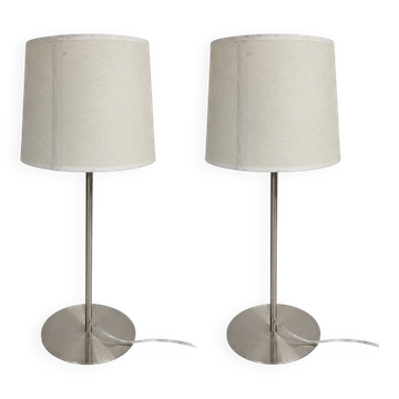Pair of large brushed metal lamps with cream shades.