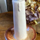 Candle holder-style lamp made entirely of ceramic.