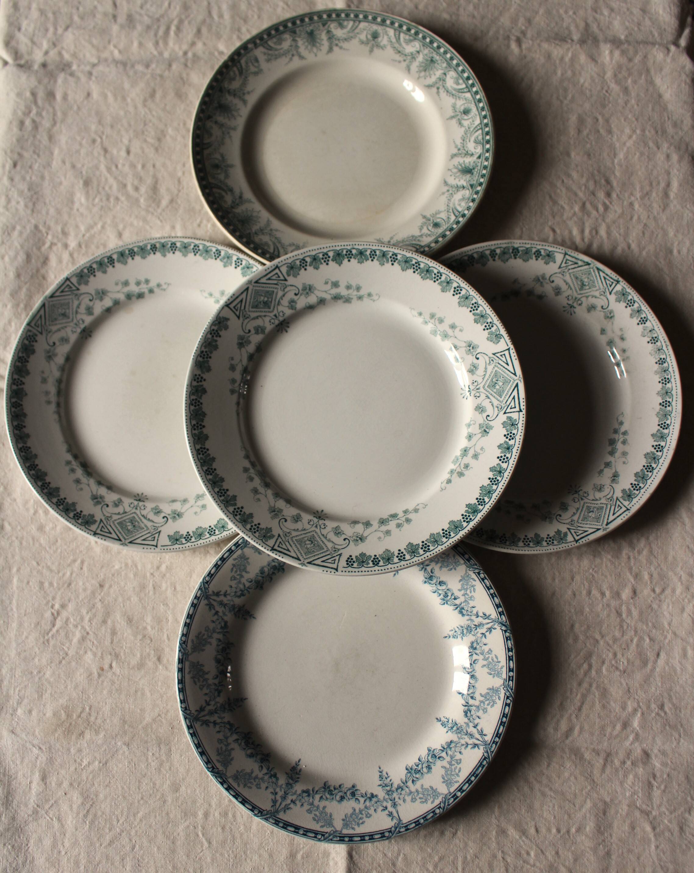 A set of 5 mismatched green blue Terre de fer flat plates