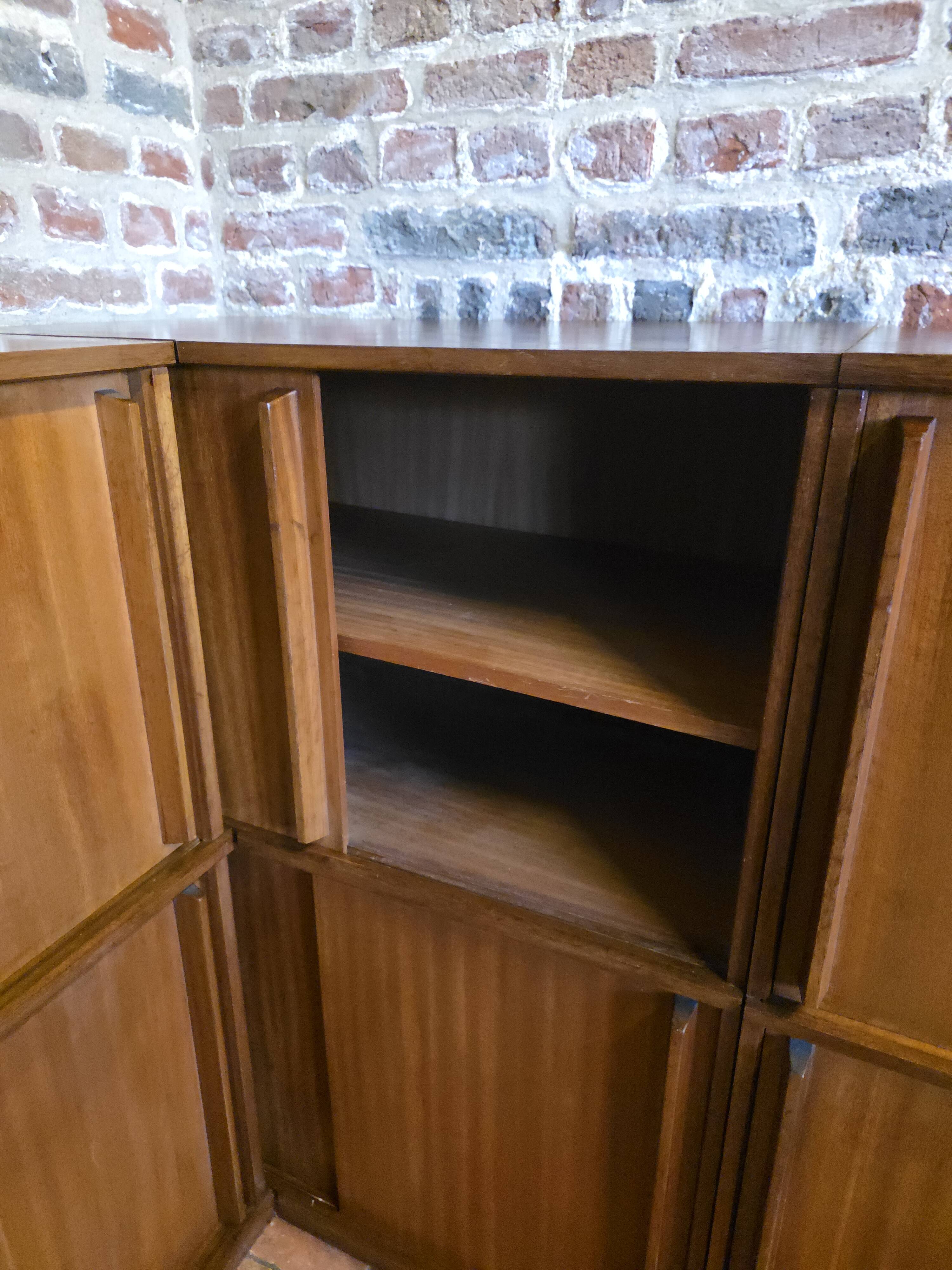 Modular corner library Oscar from the 1960s with sliding doors.