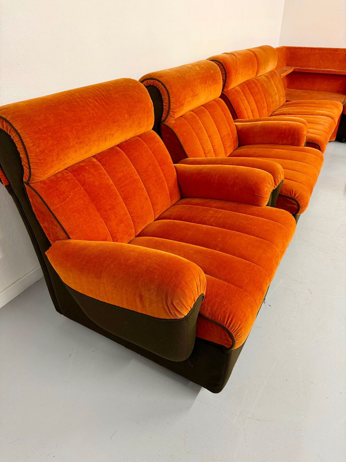 Modular vintage orange corner sofa, 1970s pop design.