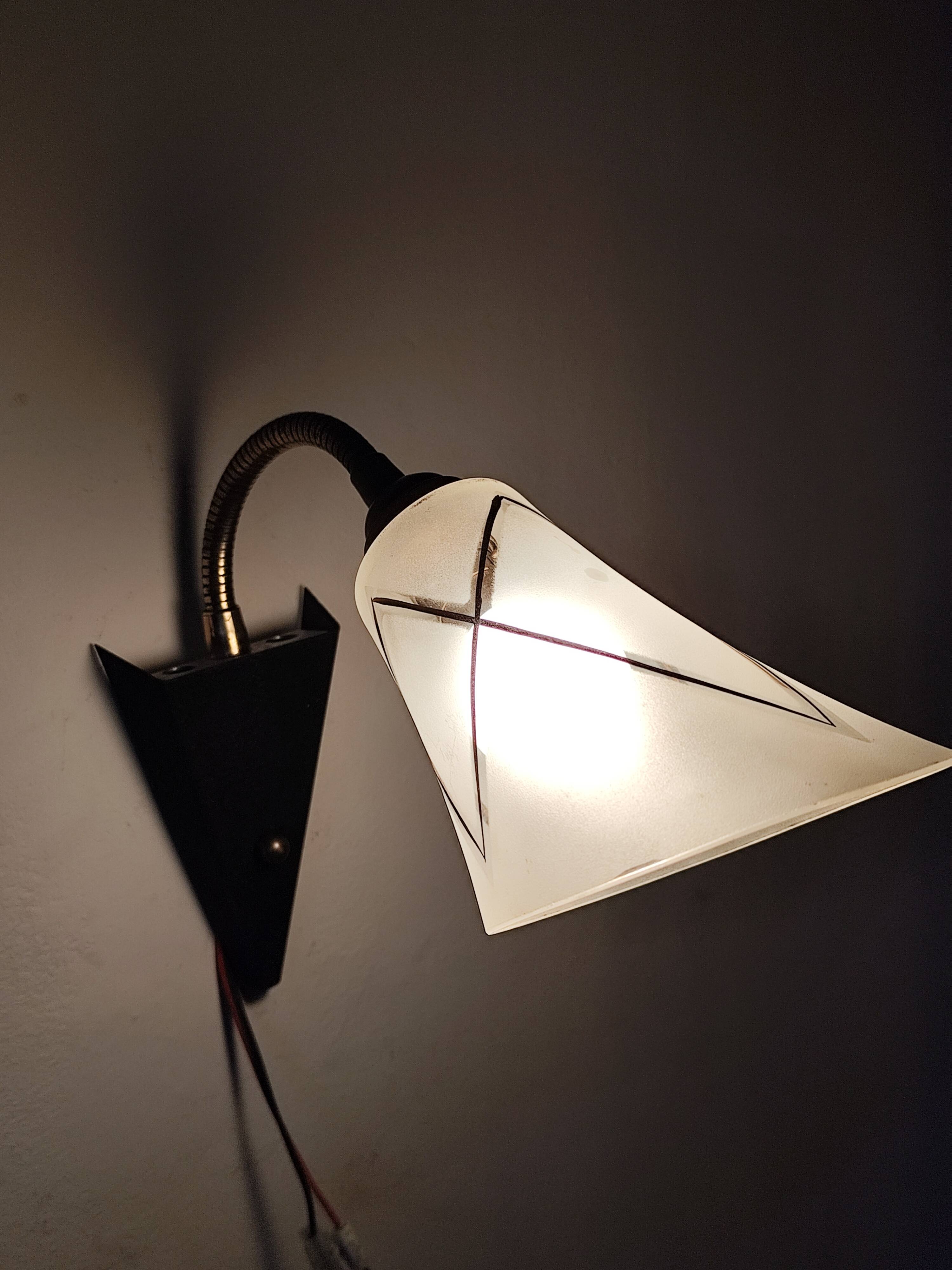 1950s wall lamp, metal, flexible brass stem and opaque shade.