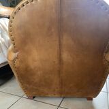 Brown leather club armchairs with an antique finish.