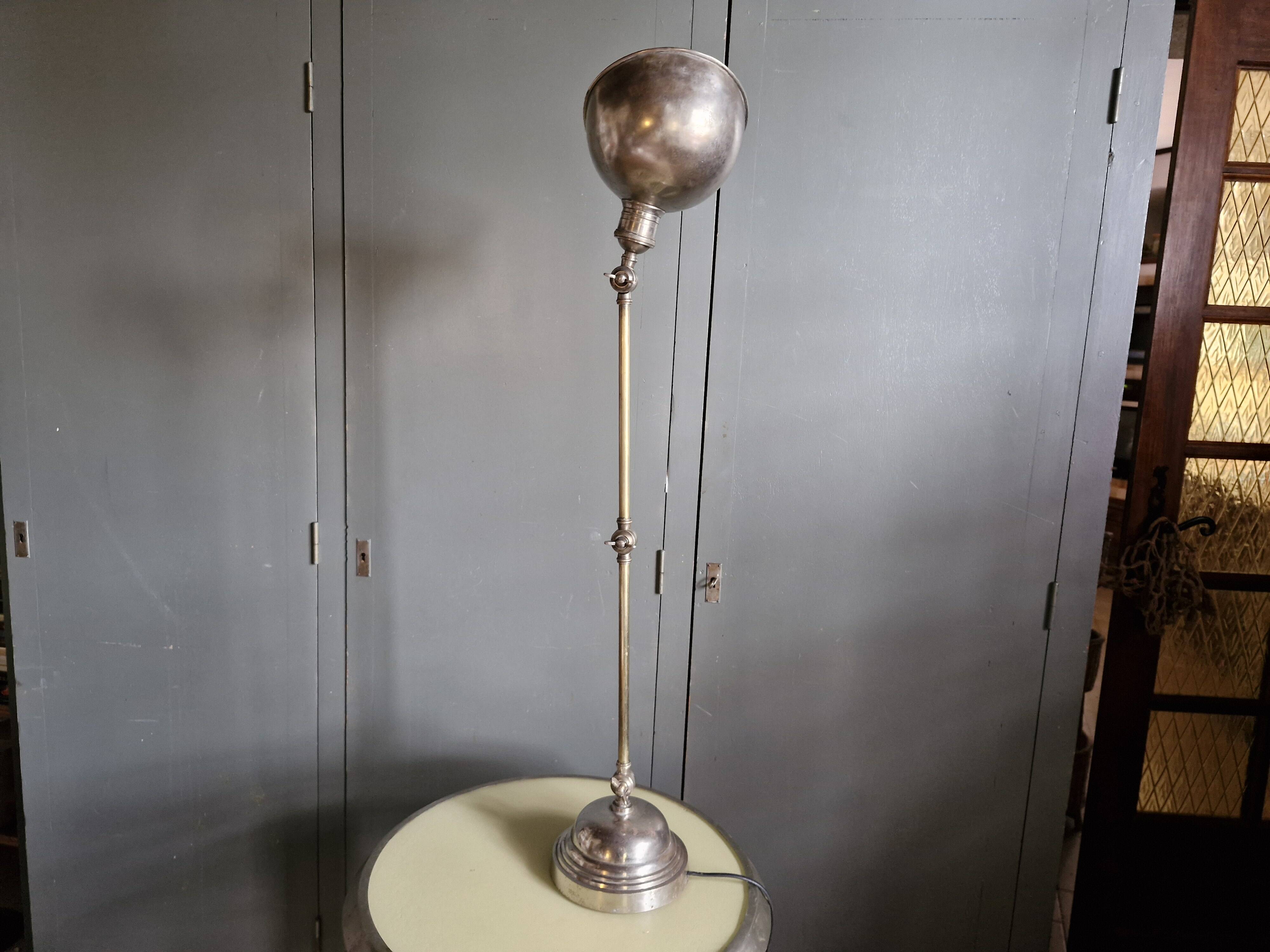 Old adjustable industrial lamp in bronze with 2 arms.
