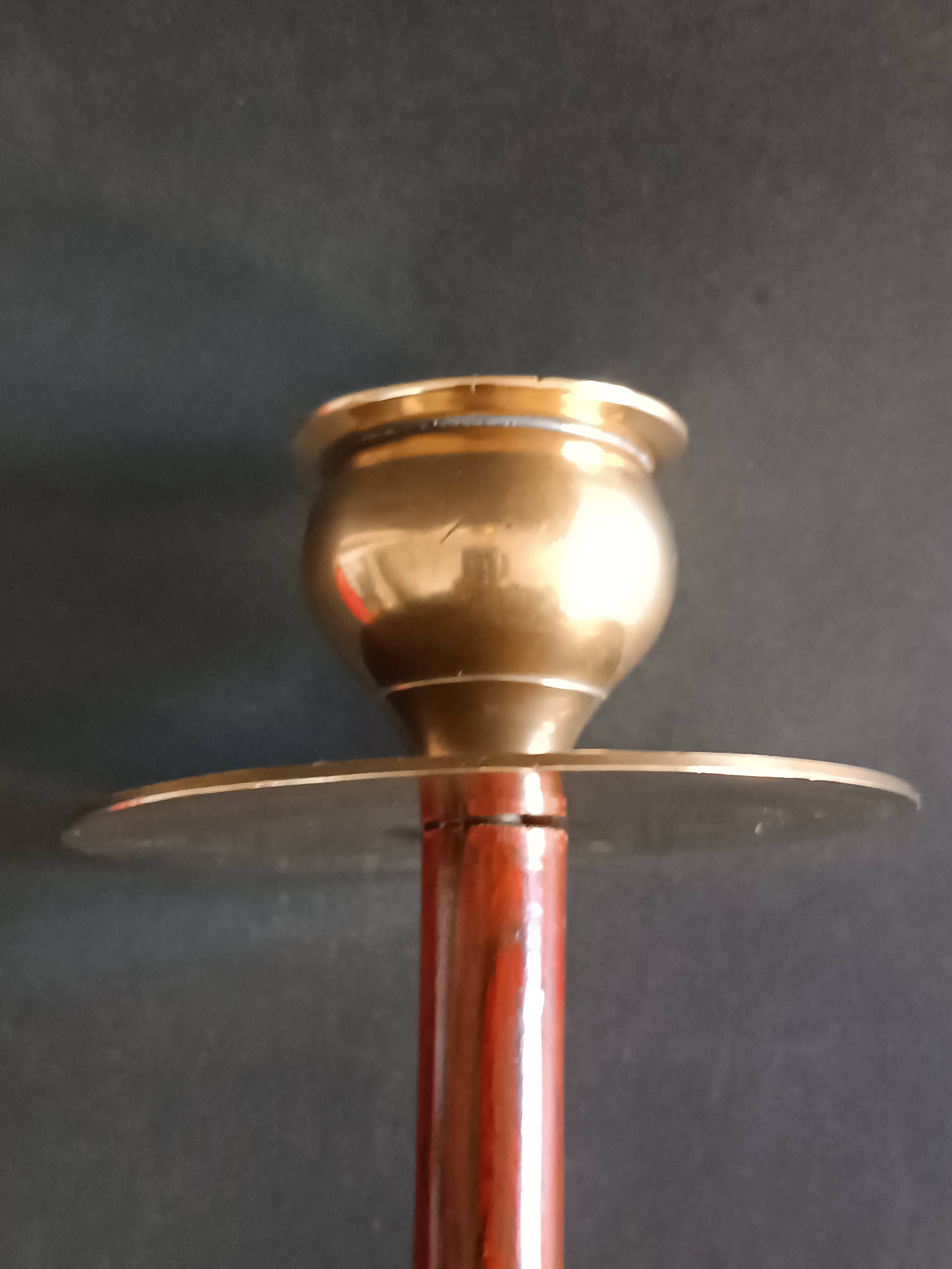 Two vintage wooden and brass candlesticks.