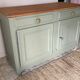 Pastel green low buffet, raw wood tray