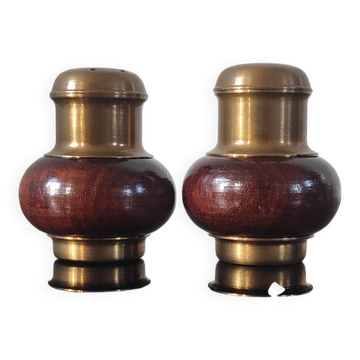 Vintage salt and pepper shaker duo in brass and turned wood.