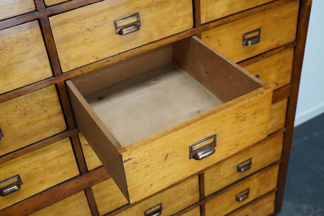 School cabinet bank of vintage Dutch drawers in mid-twentieth century pine