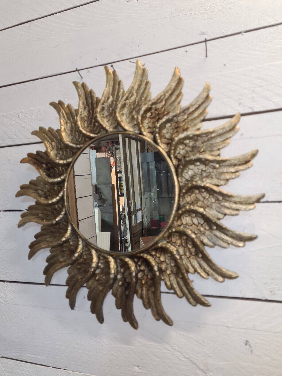 sun mirror with angel wings in golden patinated stucco