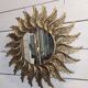 sun mirror with angel wings in golden patinated stucco
