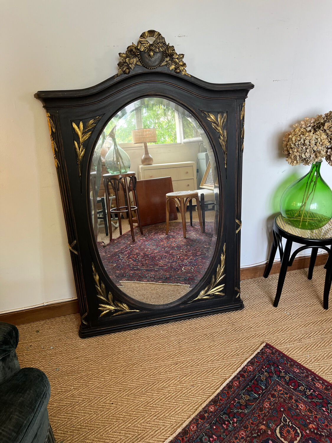 Large old trumeau mirror in black and gilded wood Napoleon style