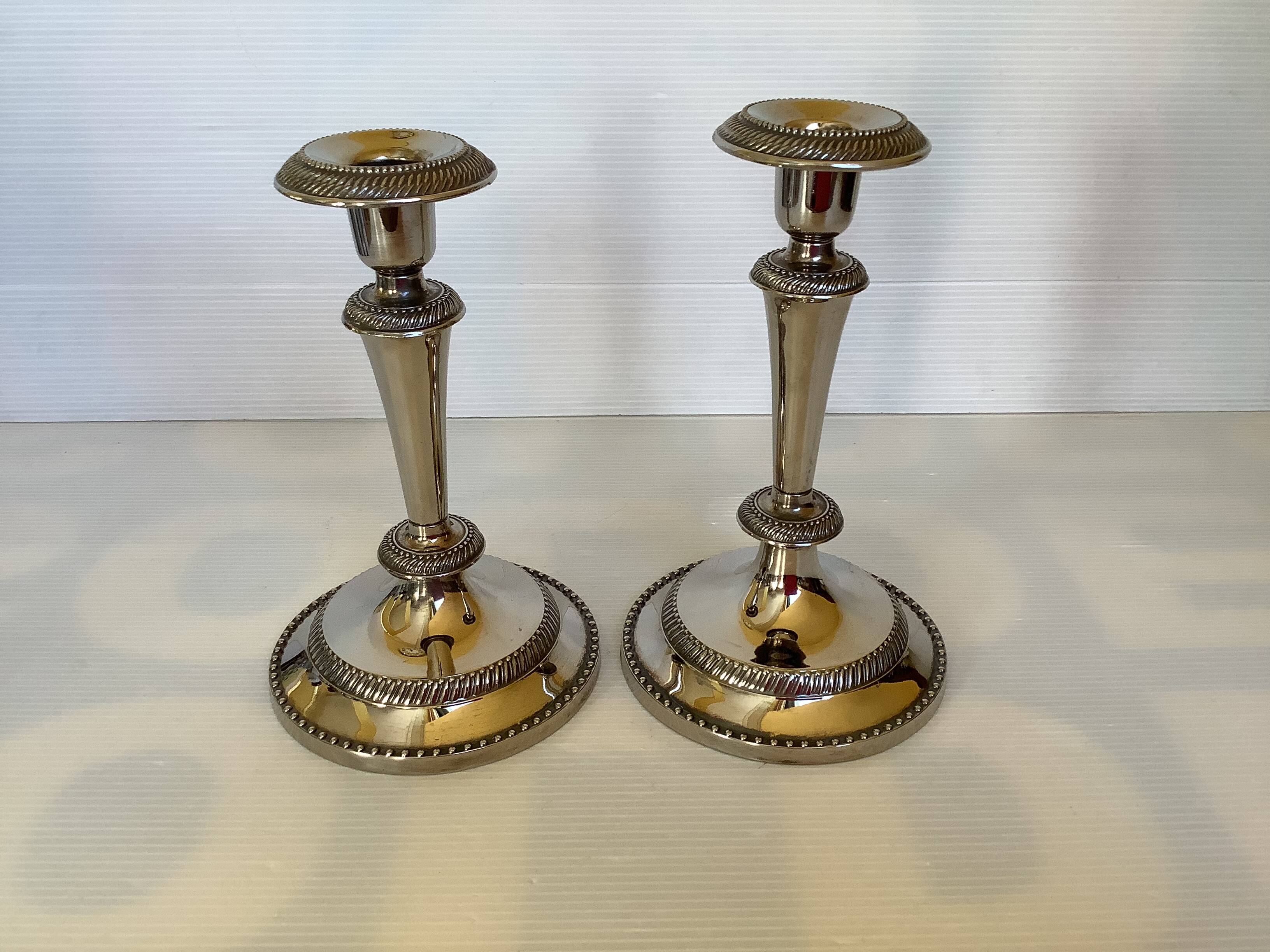 Pair of silver-plated zinc metal candlesticks